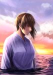  1girl brown_eyes brown_hair clouds cloudy_sky hakama horizon ishii_hisao japanese_clothes kaga_(kantai_collection) kantai_collection looking_at_viewer ocean partially_submerged shade side_ponytail sky solo twilight wind 