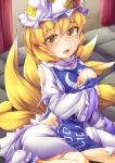  1girl absurdres blonde_hair blush breasts fox_tail fun_bo hat highres large_breasts looking_at_viewer multiple_tails open_mouth short_hair slit_pupils solo tail tears torn_clothes touhou yakumo_ran yellow_eyes 