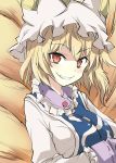  1girl blonde_hair breasts clenched_teeth fox_tail hat looking_at_viewer multiple_tails red_eyes short_hair slit_pupils smile solo suichuu_hanabi tail teeth touhou upper_body yakumo_ran 