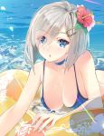  1girl :o bare_arms bare_shoulders bikini blue_bikini blue_eyes blush breasts choker cleavage collarbone day eyebrows eyebrows_visible_through_hair flower hair_flower hair_ornament hair_over_one_eye hairclip hamakaze_(kantai_collection) hanging_breasts head_tilt hibiscus innertube kantai_collection large_breasts light_rays ocean parted_lips short_hair silver_hair solo swimsuit water yahako 