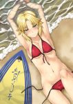  1girl armpits arms_up beach bikini blonde_hair blush collarbone fate/grand_order fate_(series) front-tie_bikini front-tie_top green_eyes lying midriff navel on_back ponytail saber_of_red sand scrunchie side-tie_bikini solo surfboard swimsuit uemukai_dai water wet 