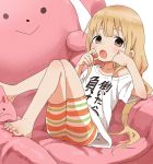  1girl barefoot bean_bag_chair blonde_hair brown_eyes candy chair futaba_anzu highres idolmaster idolmaster_cinderella_girls long_hair looking_at_viewer low_twintails lying on_back open_mouth shirt simple_background solo stuffed_animal stuffed_bunny stuffed_toy t-shirt twintails very_long_hair white_background yamamoto_souichirou you_work_you_lose 