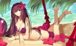  1girl anklet barefoot bikini breasts fate/grand_order fate_(series) flower gae_bolg hair_flower hair_ornament jewelry kauto long_hair looking_at_viewer lying on_stomach palm_tree polearm purple_hair red_eyes scathach_(fate/grand_order) shore solo spear swimsuit tree weapon 