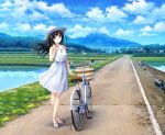  1girl bicycle black_hair blue_eyes bridge clouds cloudy_sky day dress ground_vehicle hat kazuharu_kina long_hair looking_at_viewer mountain no_socks original outdoors real_world_location rice_paddy riverbank road sandals scenery sky sleeveless smile solo sun_hat sundress white_dress 