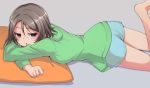  1girl blue_eyes blurry blush brown_hair depth_of_field hood hoodie love_live! love_live!_sunshine!! lying nanotsuki on_stomach open_mouth short_hair solo watanabe_you 