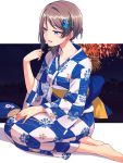  1girl alternate_hairstyle barefoot blue_eyes brown_hair checkered_kimono fan fireworks floral_print flower hair_flower hair_ornament half-closed_eyes hand_on_lap highres holding_fan japanese_clothes kimono love_live! love_live!_sunshine!! nanotsuki obi open_mouth sash sitting smile solo watanabe_you yokozuwari yukata 