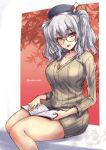  1girl :d alternate_costume beret bespectacled blue_eyes breasts collarbone glasses hat kantai_collection kashima_(kantai_collection) large_breasts long_sleeves looking_at_viewer magazine open_mouth red-framed_eyewear ribbed_sweater shinshin silver_hair sitting smile solo sweater tsurime twintails twitter_username wavy_hair 