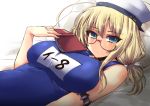  1girl ahoge armband bare_shoulders blonde_hair blue_eyes blue_swimsuit blush book breasts glasses hair_ribbon hat holding holding_book i-8_(kantai_collection) kantai_collection large_breasts looking_at_viewer low_twintails lying name_tag on_back one-piece_swimsuit open_book peaked_cap pillow red-framed_eyewear ribbon sailor_hat school_swimsuit semi-rimless_glasses shinshin solo swimsuit twintails under-rim_glasses white_hat 