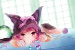  1girl animal_ears cat_ears indoors looking_at_viewer lying on_stomach original pink_hair solo violet_eyes 