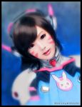  1girl artist_name asian bangs black_border black_eyes black_hair bodysuit border bunny_print d.va_(overwatch) edd_hortillosa facepaint facial_mark headphones high_collar highres long_hair looking_at_viewer overwatch photorealistic pilot_suit portrait ribbed_bodysuit shoulder_pads signature skin_tight solo swept_bangs whisker_markings 