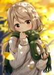  1girl ahoge autumn autumn_leaves beige_hair blurry_background blush brown_eyes covering_mouth dappled_sunlight eyebrows eyebrows_visible_through_hair falling_leaves ginkgo green_scarf grey_sweater hair_between_eyes head_tilt holding hyuuga_azuri jpeg_artifacts leaf long_hair long_sleeves looking_at_viewer original outdoors scarf sleeves_past_wrists sunlight sweater tareme 