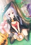  1girl blush breasts candy cape capelet cat cleavage commentary food garter_belt garter_straps gift halloween hat highres kneeling lantern massan original pumpkin silver_hair smile solo tree witch witch_hat 