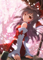  1girl ascot blush bow brown_eyes brown_hair cherry_blossoms closed_mouth commentary_request cup detached_sleeves falling_petals frilled_bow frilled_hair_tubes frills hair_bow hair_tubes hakurei_reimu highres lens_flare long_hair looking_at_viewer petals pink_petals red_bow red_skirt ribbon-trimmed_sleeves ribbon_trim sitting skirt skirt_set smile solo touhou yamu_(reverse_noise) yellow_ascot yunomi 