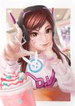  +_+ 1girl bangs beads blurry brown_eyes brown_hair casual charm_(object) chin_rest clothes_writing cup d.va_(overwatch) depth_of_field dessert drink emblem eyelashes facial_mark food headphones index_finger_raised indoors lips long_hair long_sleeves looking_at_viewer mecha meka_(overwatch) nail_art nail_polish nose overwatch pink_nails reaching restaurant signature smile solo subaru01rins sweatshirt swept_bangs tsurime upper_body whipped_cream whisker_markings wristband 