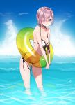  1girl bikini blush breasts cleavage collarbone fate/grand_order fate_(series) front-tie_bikini front-tie_top gluteal_fold hair_over_one_eye highres innertube looking_at_viewer nito_(siccarol) ocean outdoors purple_hair shielder_(fate/grand_order) short_hair side-tie_bikini smile solo swimsuit violet_eyes white_bikini 