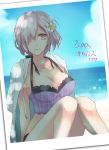  1girl bangs beach bikini blue_sky breasts cleavage clouds fate/grand_order fate_(series) flower frilled_bikini frills hair_flower hair_ornament hair_over_one_eye jacket_on_shoulders large_breasts ocean orii orii_(orii_i) purple_hair shielder_(fate/grand_order) short_hair sky smile solo swimsuit violet_eyes 