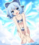  1girl :d bent_over bikini blue_bikini blue_eyes blue_hair blue_sky blush cirno clouds do_(4-rt) dutch_angle fang fangs hair_ribbon highres ice ice_wings looking_at_viewer midriff navel open_mouth partially_submerged ribbon short_hair sky smile solo swimsuit touhou wading water wet wings 