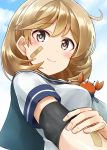  1girl ahoge bandaid bandaid_on_arm bandaid_on_face blush breasts brown_eyes brown_hair clouds cloudy_sky crab elbow_pads elbow_sleeve hand_on_arm highres kamelie kantai_collection looking_at_viewer medium_breasts oboro_(kantai_collection) pink_eyes school_uniform short_hair sky smile solo 