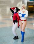  2girls batman_(series) blonde_hair callmepowergirl cleavage_cutout cosplay crossed_arms cutout dc_comics harley_quinn harley_quinn_(cosplay) leotard multiple_girls photo power_girl power_girl_(cosplay) superman_(series) two-tone_hair 