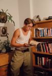  1boy atlantis belt book bookshelf cosplay desk disney glasses male_focus milo_thatch photo picture_frame plant potted_plant reading shelf tank_top theodore_roosevelt 