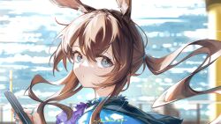  1girl absurdres amiya_(arknights) arknights artist_name ascot blue_eyes blurry blurry_background brown_hair cellphone chinese_commentary close-up commentary_request highres holding holding_phone hood hood_down infection_monitor_(arknights) jewelry lens_flare long_hair moloo27 multiple_rings parted_lips phone purple_ascot ring sideways_glance solo upper_body 