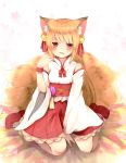  1girl animal_ears bell between_legs blonde_hair blush chita_(ketchup) detached_sleeves floral_background flower fox_ears fox_tail hair_bell hair_ornament hakama_skirt hand_between_legs hand_on_own_shoulder highres long_hair looking_at_viewer multiple_tails nontraditional_miko obi original parted_lips platform_footwear red_eyes sash signature sitting solo tail wariza wrist_cuffs 