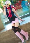  1girl beanie boots cosplay hat hikari_(pokemon) photo pink_shoes pink_skirt pokemon scarf shoes sitting skirt smile 