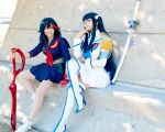  2girls black_hair cosplay glay junketsu kill_la_kill kiryuuin_satsuki long_hair matoi_ryuuko multiple_girls photo school_uniform senketsu sitting skirt smile sword technoranma weapon 