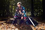  1girl breasts brown_hair cosplay fingerless_gloves forest gloves highres jewelry large_breasts nature necklace photo piercing short_hair sitting solo sword the_witcher tree ves_(the_witcher) weapon 