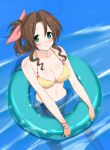  1girl aerith_gainsborough bikini blush bow breasts brown_hair cleavage final_fantasy final_fantasy_vii from_above green_eyes hair_bow hair_up hamoni innertube looking_at_viewer looking_up midriff navel partially_submerged side-tie_bikini smile solo swimsuit water 