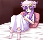  1girl bed blush bococho crescent female hat long_hair patchouli_knowledge pillow purple_hair red_eyes socks solo touhou 