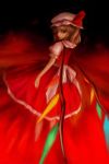  1girl blonde_hair dress female fire flame flandre_scarlet frills from_behind hat looking_at_viewer mob_cap oisin puffy_short_sleeves puffy_sleeves red_dress red_eyes short_sleeves side_ponytail solo standing touhou wings 