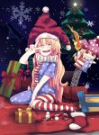  1girl american_flag_legwear american_flag_shirt b.d blonde_hair blush candy candy_cane christmas christmas_stocking christmas_tree christmas_wreath clownpiece food gift hat highres jack_in_the_box_(toy) jester_cap long_hair neck_ruff open_mouth red_eyes santa_hat short_sleeves sitting snowflakes solo torch touhou v very_long_hair wariza 