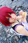  blue_eyes cosplay jewelry kairi kingdom_hearts lowres necklace photo red_hair redhead short_hair sitting solo 
