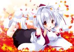  1girl animal_ears autumn_leaves bare_shoulders blush breasts detached_sleeves hat hikanyan inubashiri_momiji leaf looking_at_viewer lying on_stomach open_mouth pom_pom_(clothes) red_eyes short_hair silver_hair solo tail tokin_hat touhou wolf_ears wolf_tail 