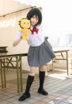  1girl asian black_hair bleach cosplay hair_between_eyes kon kuchiki_rukia photo school_uniform serafuku skirt solo stuffed_animal stuffed_lion stuffed_toy 