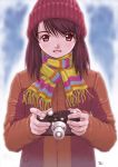  1girl beanie brown_hair camera fringe hat holding holding_camera kobayashi_yuji looking_at_viewer red_eyes scarf signature smile solo standing striped upper_body winter 