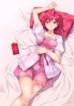 1girl bangs bed digital_media_player dress earrings follen_(639594) headphones highres jewelry layered_dress looking_at_viewer lying on_back original parted_lips pillow pink_dress red_ribbon redhead ribbon short_dress short_hair solo yellow_eyes 