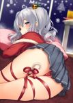  1girl alternate_costume ass bell blue_eyes blurry blush candy candy_cane capelet christmas closed_mouth depth_of_field drinking_straw eyebrows_visible_through_hair food from_behind fur_trim glass hair_bell hair_ornament highres indoors kantai_collection kashima_(kantai_collection) long_sleeves lying miniskirt no_headwear on_floor panties pantyshot pantyshot_(lying) pillow plate pleated_skirt pokachu red_panties red_ribbon red_sweater ribbon silver_hair skindentation skirt smile snowflakes solo star table thigh_ribbon twintails underwear upskirt wavy_hair 