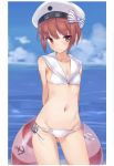  1girl arms_behind_back auburn_hair bikini breasts brown_eyes brown_hair cleavage clothes_writing clouds cloudy_sky cowboy_shot groin hat highres kantai_collection lifebuoy looking_at_viewer lowleg lowleg_bikini metindone midriff sailor_bikini sailor_collar sailor_hat short_hair sky small_breasts swimsuit thighs water white_bikini white_hat z3_max_schultz_(kantai_collection) 
