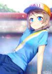  1girl artist_name blue_eyes blurry blush brown_hair commentary_request depth_of_field hat looking_at_viewer love_live! love_live!_sunshine!! marshall_(wahooo) peaked_cap shirt short_hair smile solo t-shirt watanabe_you 