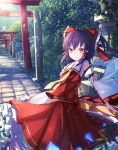  1girl ascot bow brown_hair bush dappled_sunlight day detached_sleeves frilled_skirt frills hair_bow hair_tubes hakurei_reimu highres japanese_clothes koyuki_ekaki looking_at_viewer miko outdoors ribbon-trimmed_sleeves ribbon_trim shrine skirt skirt_set smile solo sunlight torii touhou tree vanishing_point wide_sleeves wind 