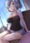  1girl alternate_costume arm_support blue_eyes blush breasts cleavage commentary_request eyebrows_visible_through_hair eyes_visible_through_hair hair_over_one_eye hamakaze_(kantai_collection) highres ichinose_kizuki indoors kantai_collection large_breasts see-through short_hair shorts silver_hair sitting solo thighs 