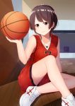  1girl absurdres akky_(akimi1127) ball basketball basketball_uniform bike_shorts black_eyes breasts brown_hair clothes_writing commentary_request highres holding holding_ball indoors medium_breasts original shoes short_hair shorts smile sneakers solo sportswear uniform 
