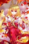  1girl 2015 animal_ears autumn_leaves bare_shoulders blonde_hair breasts detached_sleeves felicia-val flower fox fox_ears fox_tail hakama hakama_skirt japanese_clothes leaf long_hair looking_at_viewer multiple_tails open_mouth original red_eyes signature solo tail very_long_hair 
