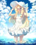  1girl bare_shoulders blonde_hair blush braid breasts dress green_eyes hat highres lillie_(pokemon) long_hair looking_at_viewer ocean pokemon pokemon_(game) pokemon_sm sleeveless sleeveless_dress solo sun_hat yelsh 