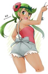  1girl absurdres ass blush breasts cowboy_shot dark_skin flower from_behind green_eyes green_hair hair_flower hair_ornament highres holding kirikirimai_(kkm) ladle long_hair looking_at_viewer looking_back mallow_(pokemon) medium_breasts open_mouth overalls pokemon pokemon_(game) pokemon_sm signature solo trial_captain twintails twitter_username 