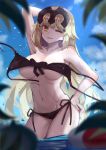  1girl alternate_costume armpits beach bikini black_bikini blonde_hair breasts fate/grand_order fate_(series) forehead_protector groin hand_in_hair hand_on_hip jeanne_alter large_breasts licking_lips looking_at_viewer one_eye_closed ruler_(fate/apocrypha) ryuuno6 shiny shiny_skin solo swimsuit toned tongue tongue_out under_boob wardrobe_malfunction wet yellow_eyes 