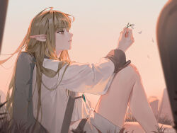  1girl absurdres against_tombstone bare_legs blonde_hair brown_eyes commentary_request dusk earclip elf falling_petals flower from_side gem green_gem hair_flowing_over highres holding holding_flower knee_up long_hair looking_ahead outdoors parted_lips petals pointy_ears robe serie_(sousou_no_frieren) shorts sitting soar_wle solo sousou_no_frieren white_petals white_robe white_shorts 
