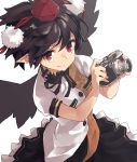 1girl black_hair black_skirt black_wings camera frilled_skirt frills hat highres holding holding_camera leaf_print looking_at_viewer nuqura pointy_ears red_pupils ribbon shameimaru_aya shiny shiny_hair shirt short_sleeves simple_background skirt solo tokin_hat touhou white_background white_shirt wind wings 